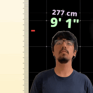 A Man With Glasses Is Standing In Front Of A Ruler That Says 277 Cm 9 1 " GIF