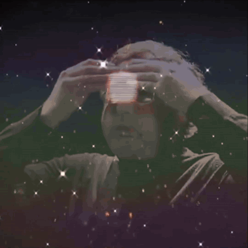 A Man With Glasses Is Surrounded By A Light Circle GIF