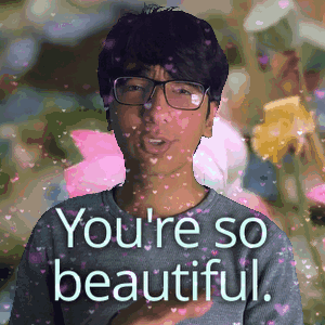 A Man With Glasses Is Surrounded By Pink Hearts And The Words You 'Re So Beautiful GIF
