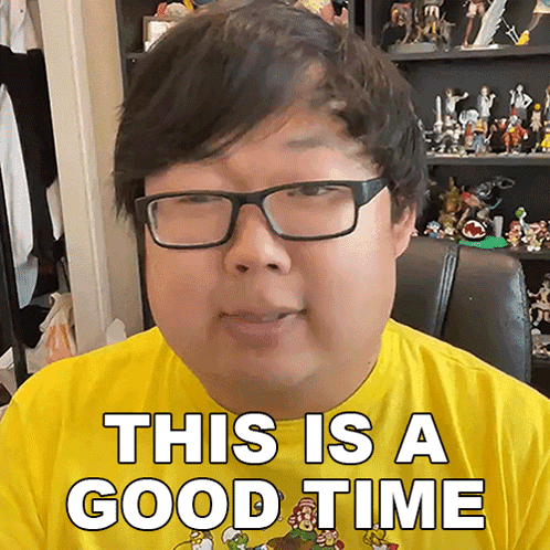 A Man With Glasses Is Wearing A Yellow Shirt That Says This Is A Good Time GIF