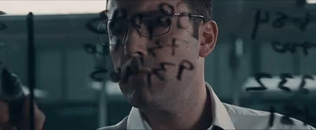 A Man With Glasses Is Writing On A Glass Wall With A Marker . GIF