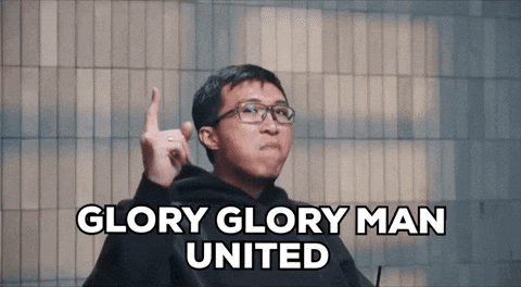 A Man With Glasses Says Glory Glory Man United With His Finger Up GIF
