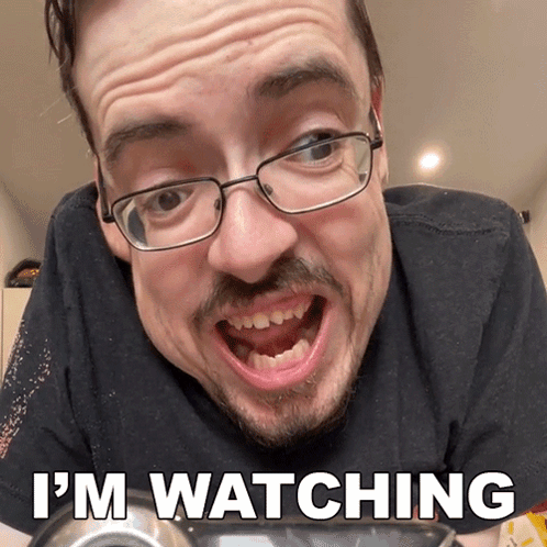 A Man With Glasses Says I 'M Watching With His Mouth Open GIF