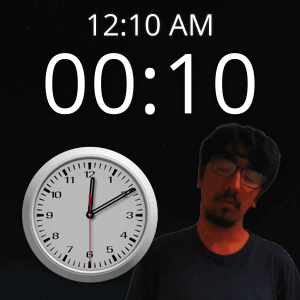 A Man With Glasses Stands In Front Of A Clock That Reads 12:10 Am GIF