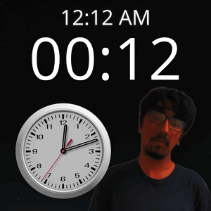 A Man With Glasses Stands In Front Of A Clock That Says 12:12 Am GIF