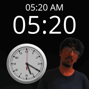 A Man With Glasses Stands In Front Of A Clock That Says 5:20 Am GIF