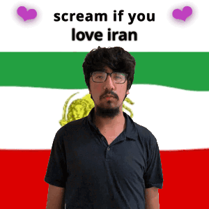 A Man With Glasses Stands In Front Of A Flag That Says Scream If You Love Iran On It GIF