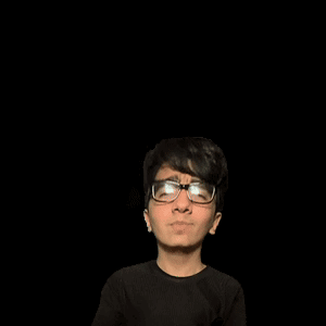 A Man With Glasses Stands In Front Of A Green A GIF