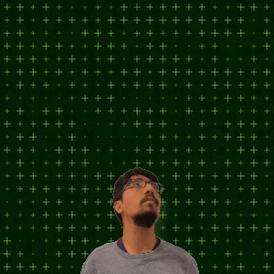 A Man With Glasses Stands In Front Of A Green Background With The Number 14 + 2 On It GIF