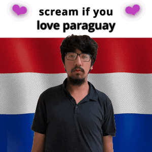 a man with glasses stands in front of a paraguay flag and says scream if you love paraguay