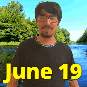 A Man With Glasses Stands In Front Of A River With The Date June 19 GIF