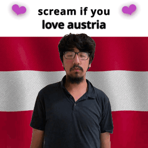 A Man With Glasses Stands In Front Of An Austria Flag GIF