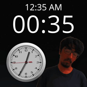 A Man With Glasses Stands Next To A Clock That Reads 12:35 Am GIF