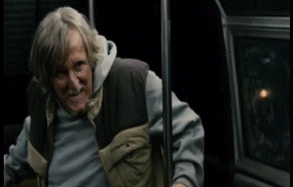 A Man With Gray Hair And A Beard Is Holding Onto A Railing With The Word Mcmuffin Written On It GIF