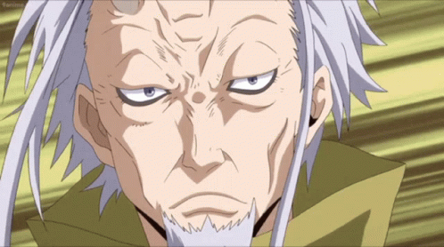 A Man With Gray Hair And A Beard Is Looking At The Camera With A Yellow Background Behind Him GIF