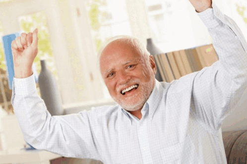 A Man With Gray Hair And A Beard Is Smiling With His Arms In The Air GIF