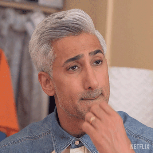 a man with gray hair and a beard is wearing a denim shirt and a netflix logo