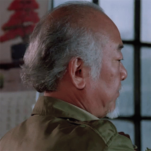 A Man With Gray Hair And A Beard Looks To His Left GIF