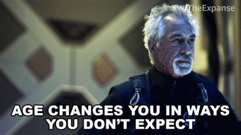 A Man With Gray Hair And A Beard Says " Age Changes You In Ways You Don T Expect " GIF
