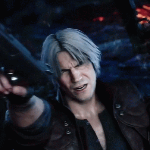 A Man With Gray Hair Is Holding A Gun In His Hand GIF