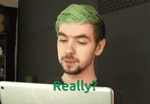 A Man With Green Hair And A Beard Is Looking At A Tablet With The Words Really Written On It GIF