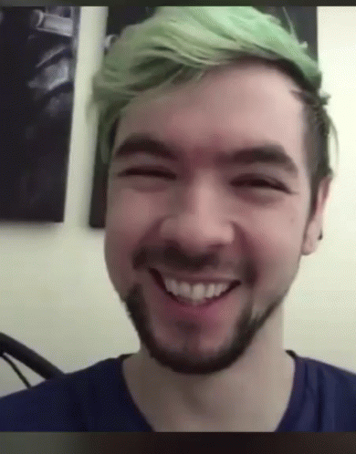 A Man With Green Hair And A Beard Is Smiling GIF