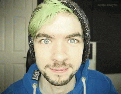 A Man With Green Hair And A Beard Wears A Blue Hoodie GIF