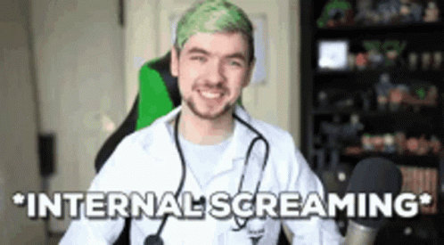 A Man With Green Hair And A Stethoscope Around His Neck Is Sitting In A Chair . GIF