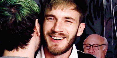 A Man With Green Hair Is Kissing Another Man GIF