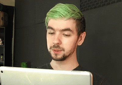 A Man With Green Hair Is Using A Tablet Computer . GIF