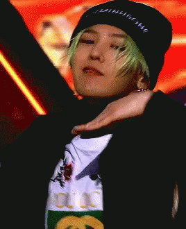 A Man With Green Hair Is Wearing A Black Beanie And A Gucci T-Shirt GIF