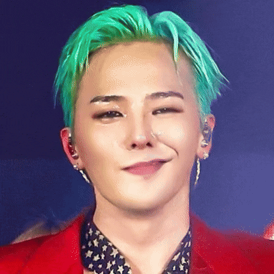 A Man With Green Hair Is Wearing A Red Jacket And Smiling GIF