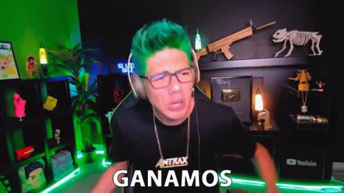 a man with green hair is wearing headphones and a shirt that says antax on it
