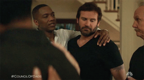 A Man With His Arm Around Another Man With The Council Of Dads Written On The Bottom Of The Screen GIF