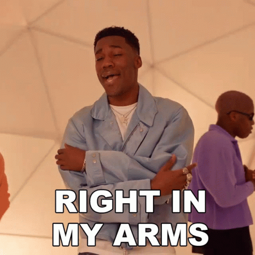 A Man With His Arms Crossed And The Words Right In My Arms GIF