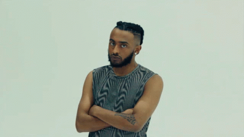 A Man With His Arms Crossed Has A Tattoo On His Arm That Says ' A ' GIF