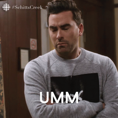 A Man With His Arms Crossed Has The Word Umm Written On His Chest GIF