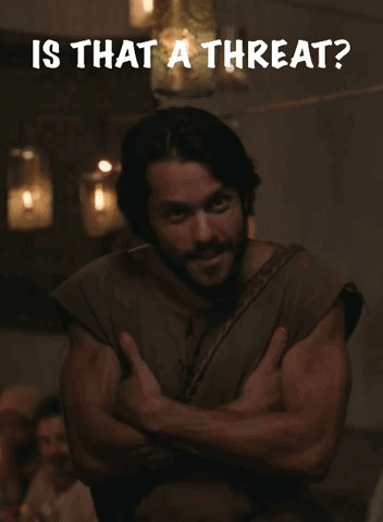A Man With His Arms Crossed Has The Words Is That A Threat Written Above Him GIF