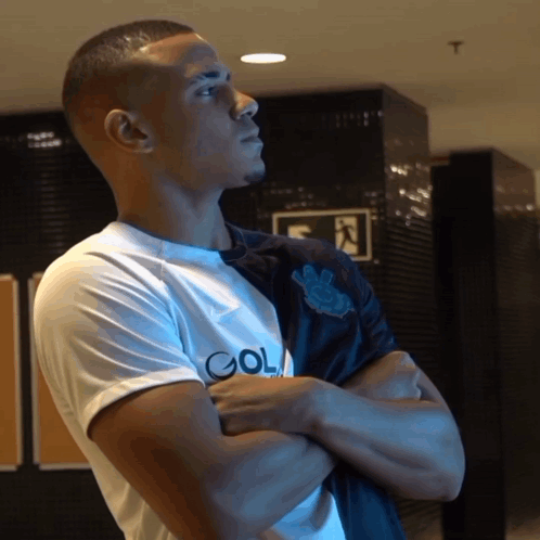 A Man With His Arms Crossed Is Wearing A Shirt That Says Gol On It GIF