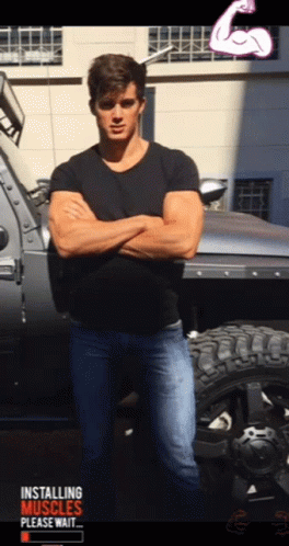 A Man With His Arms Crossed Standing In Front Of A Truck That Says Installing Muscles GIF