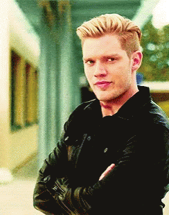 A Man With His Arms Crossed Wearing A Black Jacket GIF