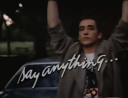 A Man With His Arms In The Air And The Words Say Anything GIF