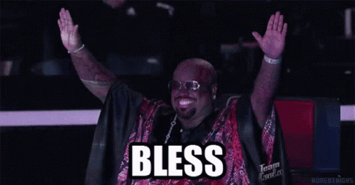 A Man With His Arms In The Air With The Word Bless Written Above Him GIF