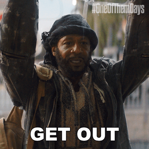 A Man With His Arms In The Air With The Words Get Out Written Below Him GIF