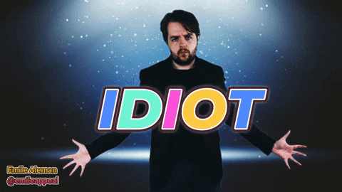 A Man With His Arms Outstretched Is Standing In Front Of The Word Idiot GIF