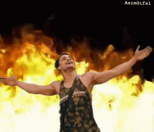 A Man With His Arms Outstretched Is Wearing A Tank Top That Says Strong On It GIF