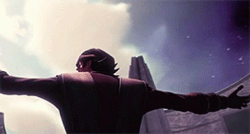 A Man With His Arms Outstretched Standing In Front Of A Building GIF