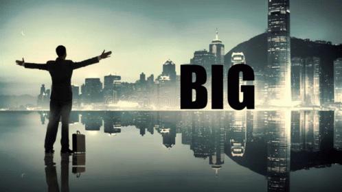 A Man With His Arms Outstretched Stands In Front Of A City With The Word Big On It GIF