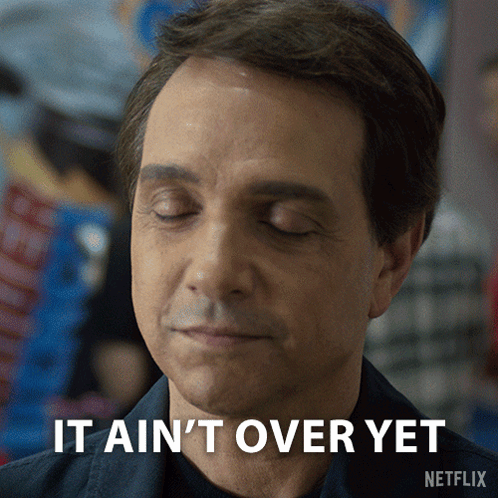 A Man With His Eyes Closed And The Words It Ain 'T Over Yet Above Him GIF