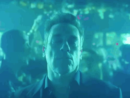 a man with his eyes closed in a blue room